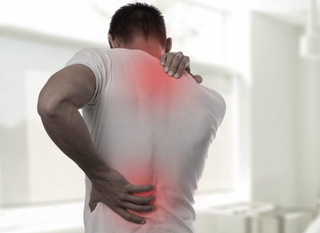 Man with muscle strain in low back and neck