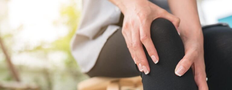 Woman holding her knee