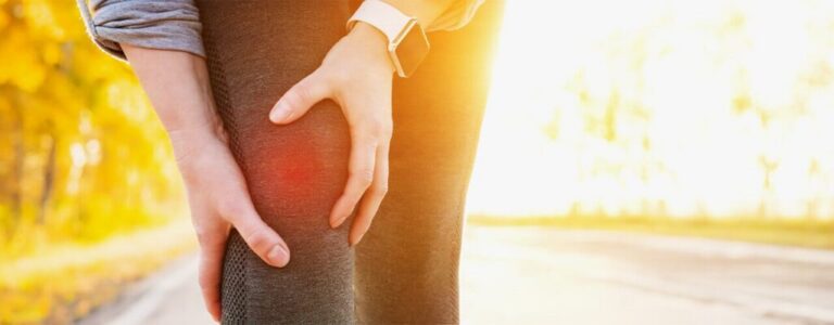 Woman holding her knee in pain